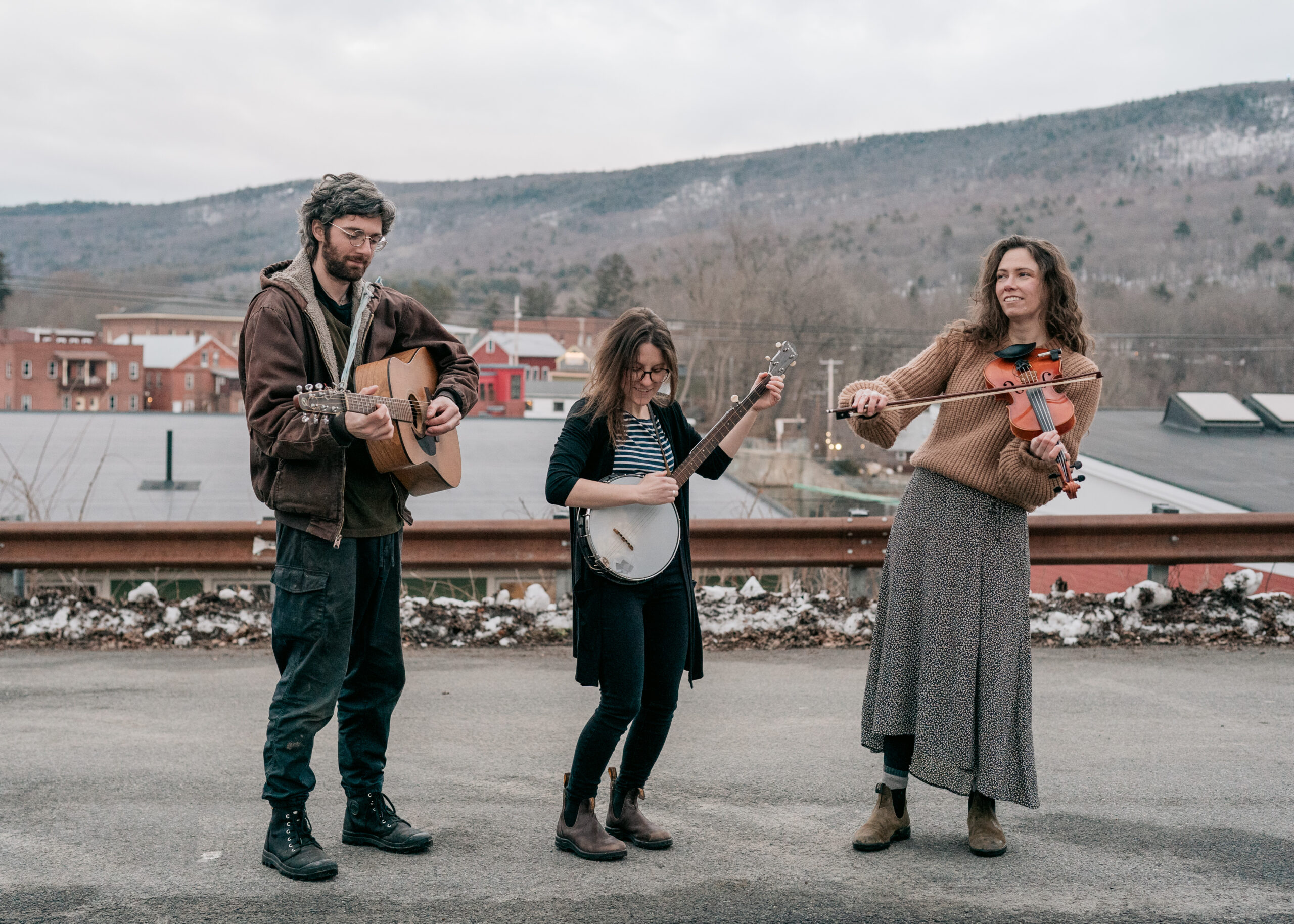 The Hilltown Ham Hocks play their instruments with Shelburne Falls in the background.